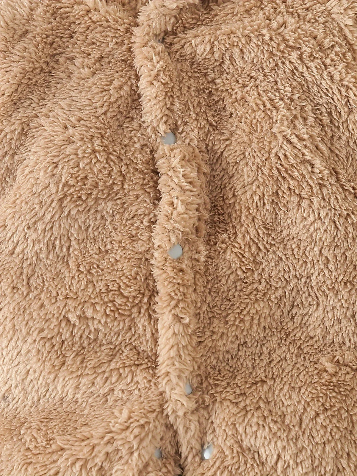 Fluffy bear romper laid flat showing zipper front