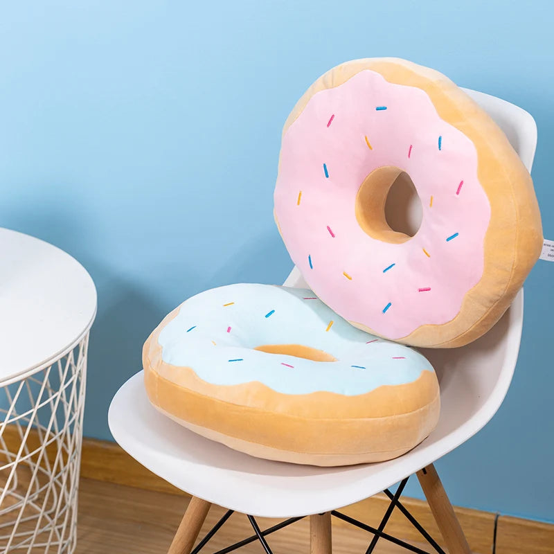 Giant donut plush pillow held in two hands