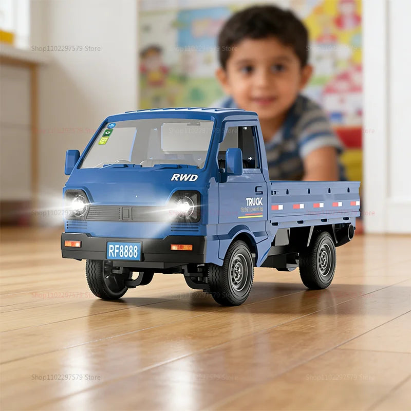Mini RC truck driving across an outdoor surface