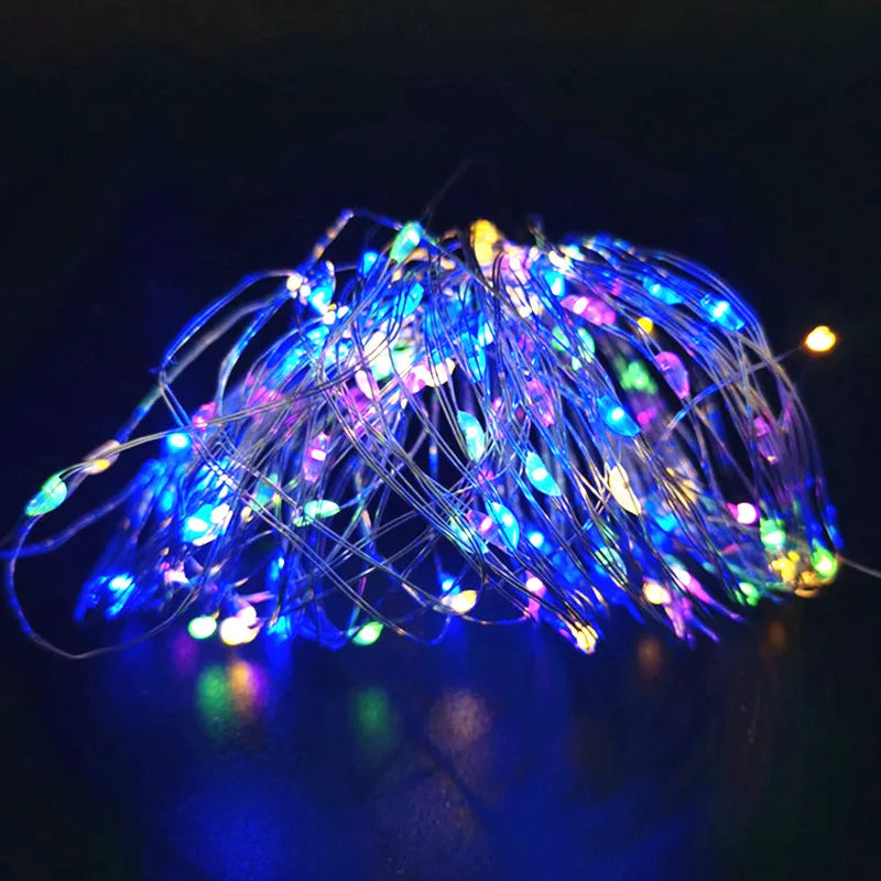 Long strand of lit copper wire lights on a bedroom wall
