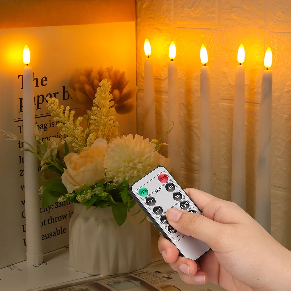 Tall LED taper candles glowing warmly in a window