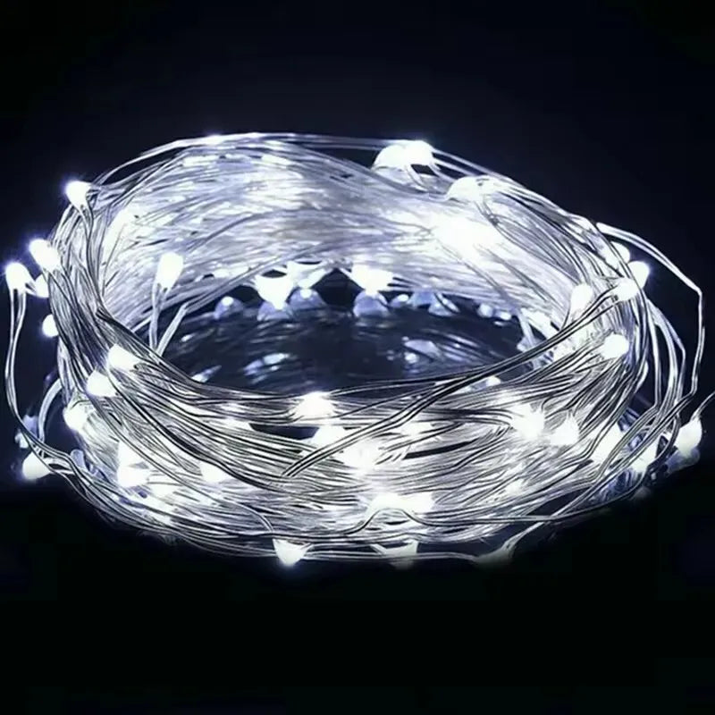 Fairy lights wrapped around a glass jar at night