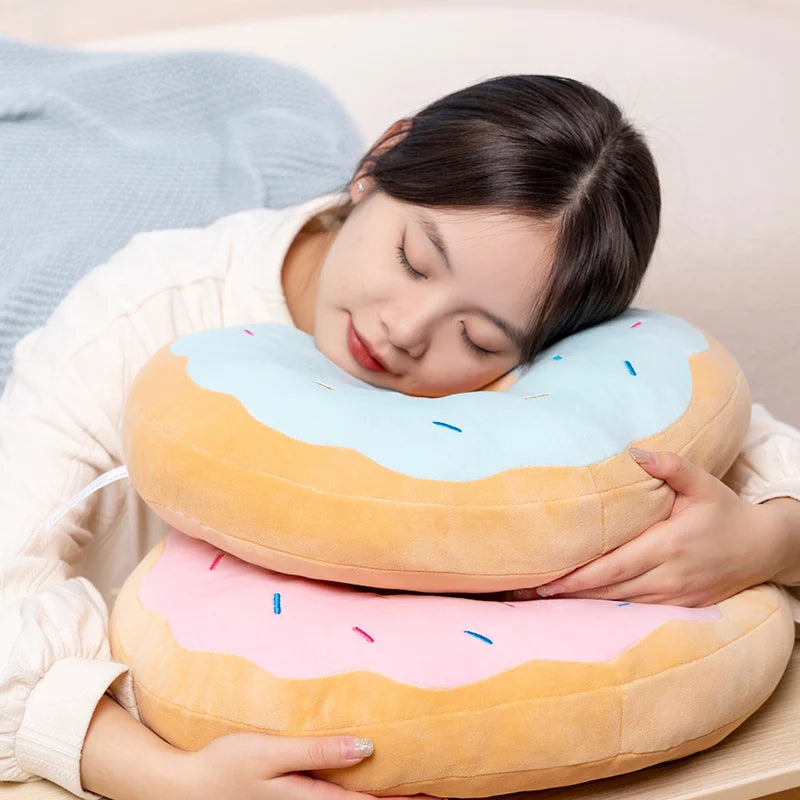 Child hugging a giant donut plush pillow