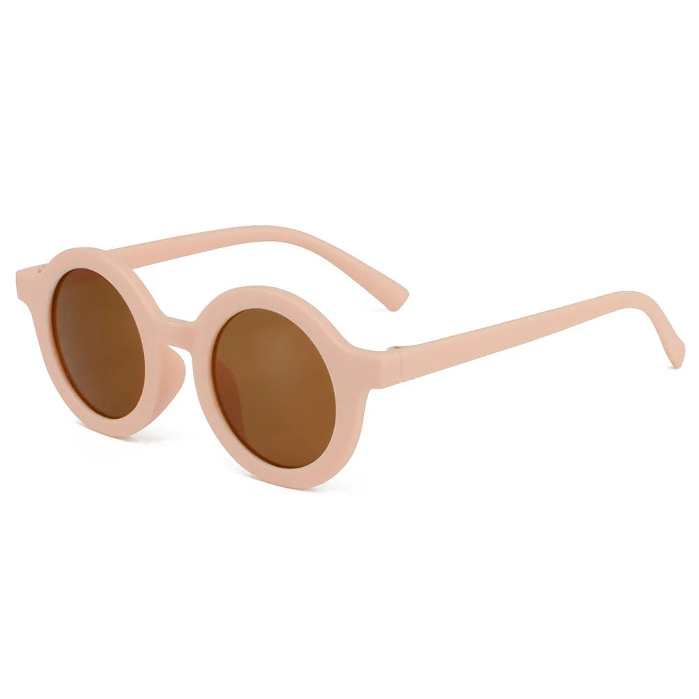 Young girl wearing round sunglasses on a sunny day