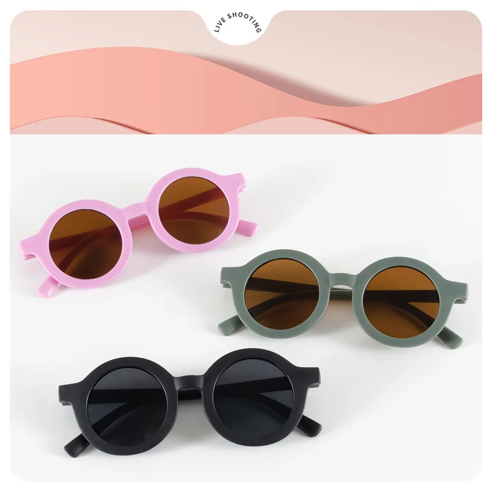 Toddler wearing kids round sunglasses outdoors in the sun