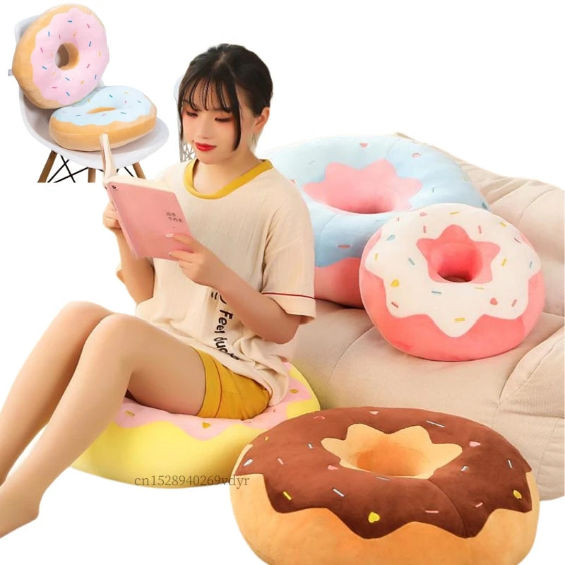 Giant donut plush pillow with pink frosting and sprinkles