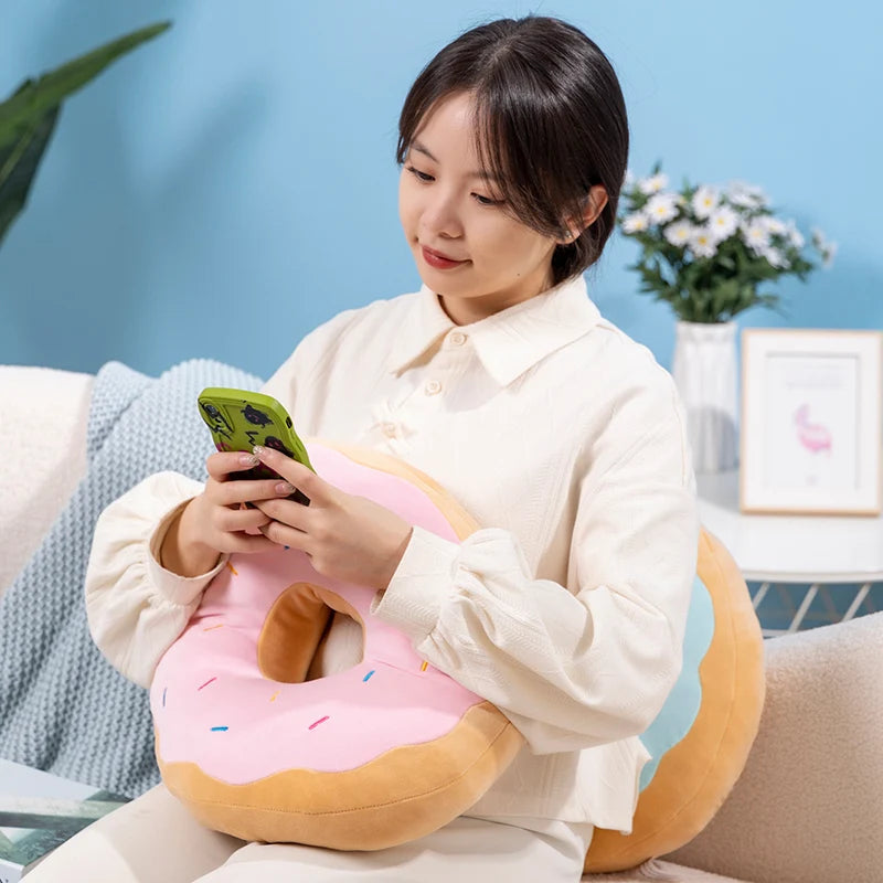 Soft donut pillow resting on a sofa