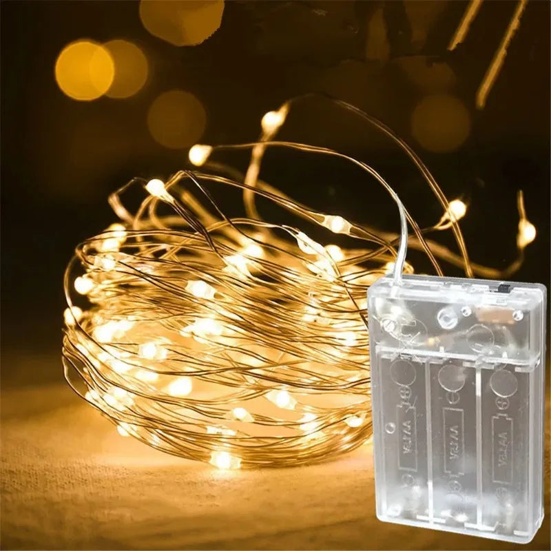 Thin copper wire strand with tiny lit LED bulbs
